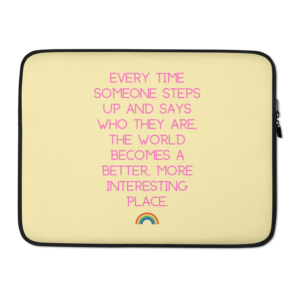Front-facing cream laptop sleeve with pink text and a small rainbow graphic