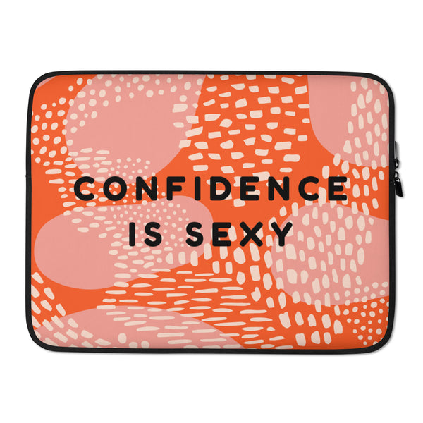 Front view of an orange and pink laptop sleeve reading “CONFIDENCE IS SEXY”