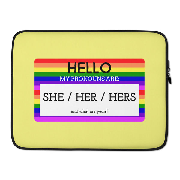 Yellow laptop sleeve with rainbow stripes and text, “Hello, my pronouns are: she / her / hers.”