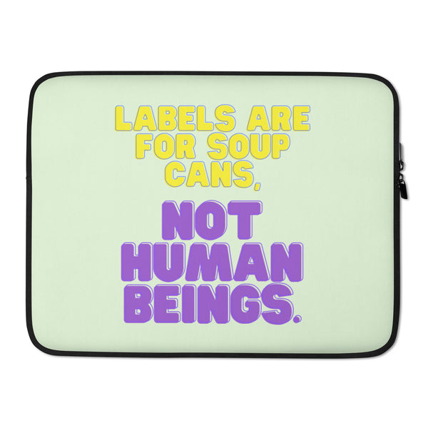 Front-facing pale green laptop sleeve reading “Labels Are For Soup Cans, Not Human Beings.”