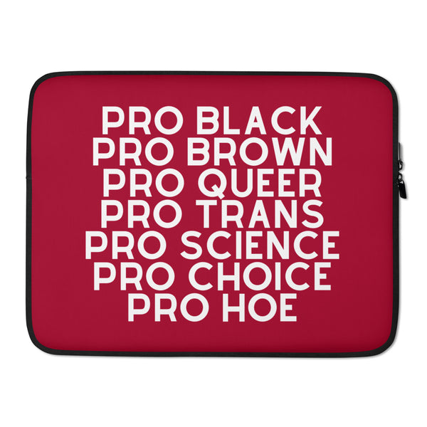 Red laptop sleeve with black trim and zipper, printed with white “PRO BLACK PRO BROWN PRO QUEER PRO TRANS PRO SCIENCE PRO...