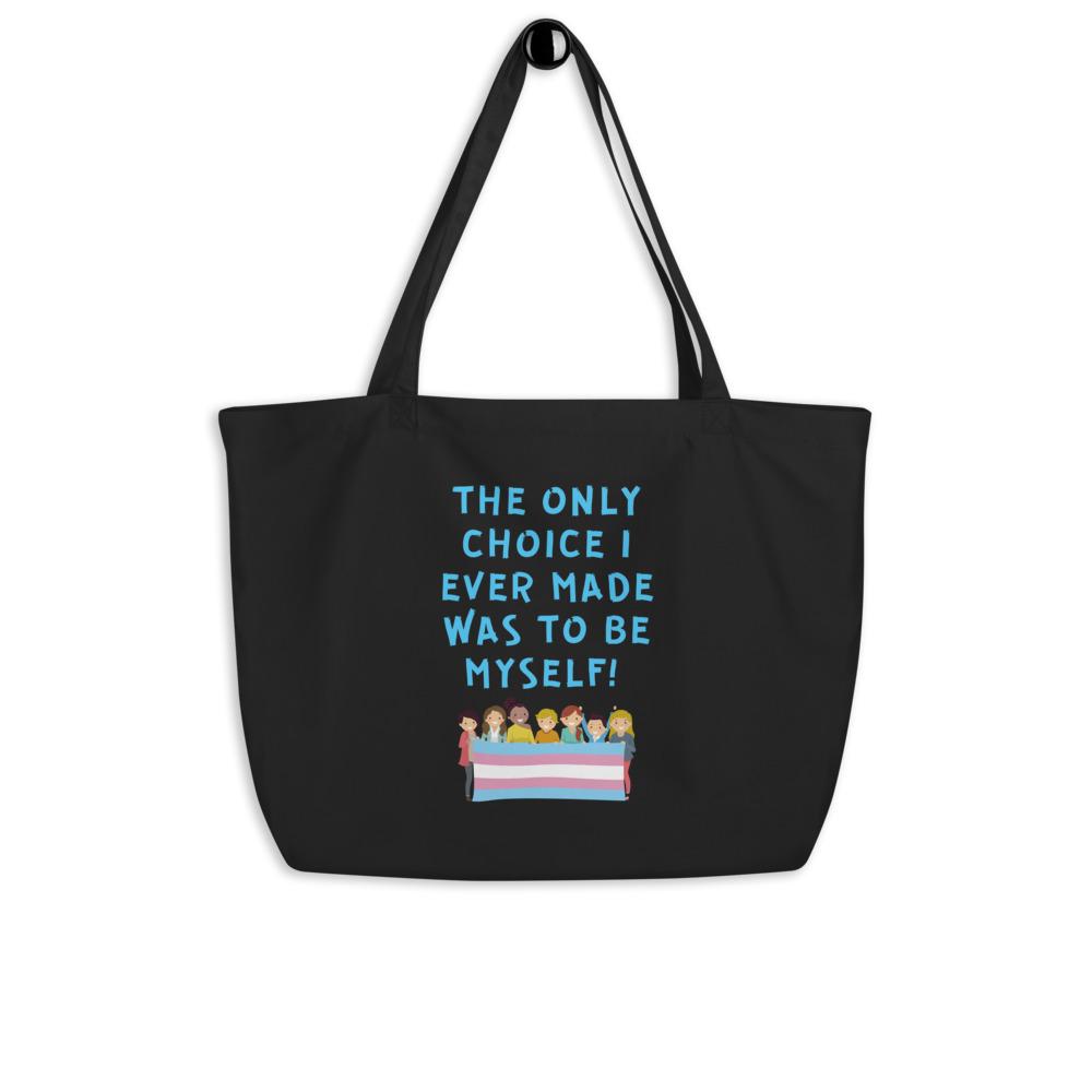 Black tote bag reading “THE ONLY CHOICE I EVER MADE WAS TO BE MYSELF!” above a trans pride flag