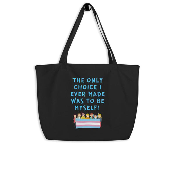 Black tote bag reading “THE ONLY CHOICE I EVER MADE WAS TO BE MYSELF!” above a trans pride flag