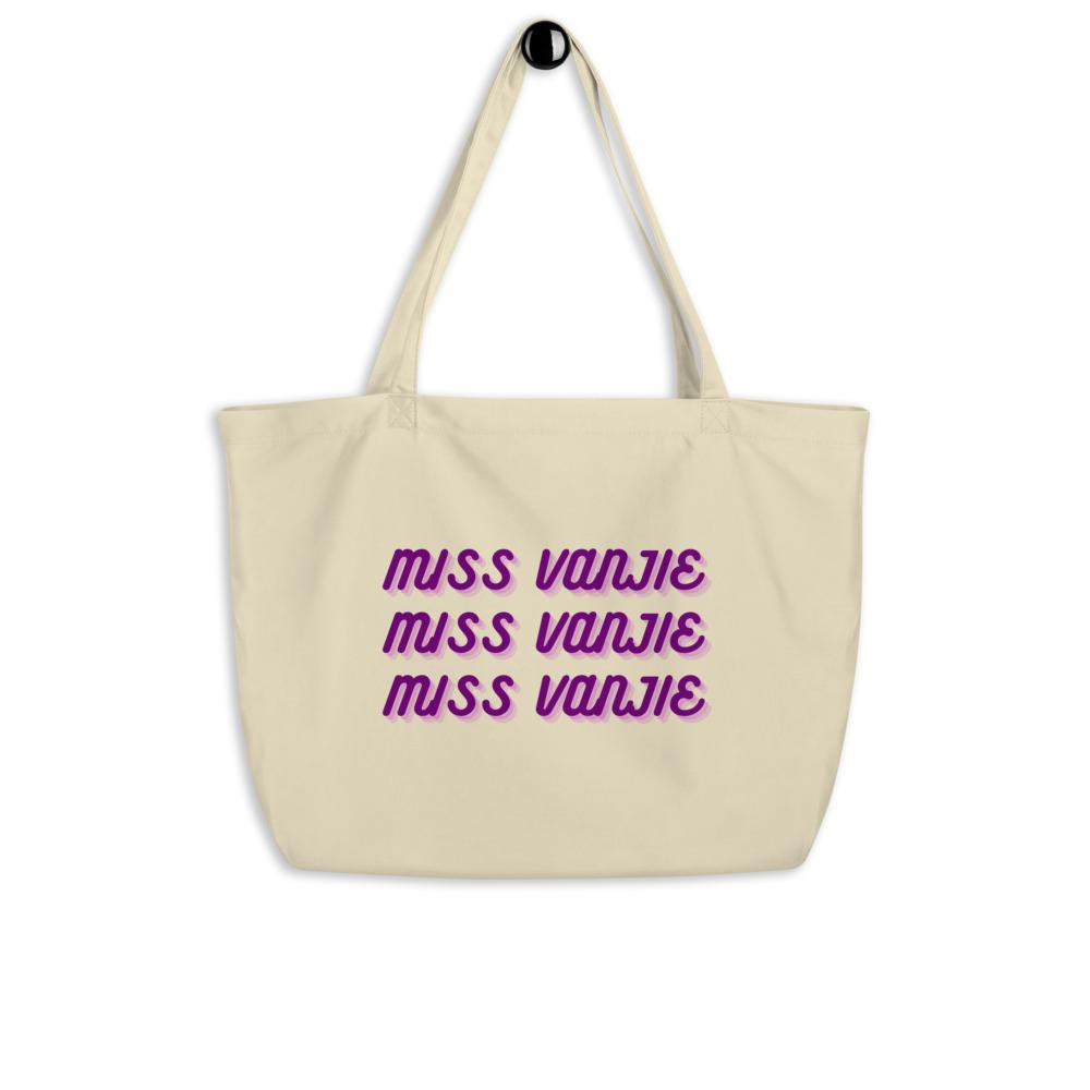 Cream canvas tote bag printed three times with purple “Miss Vanjie” lettering