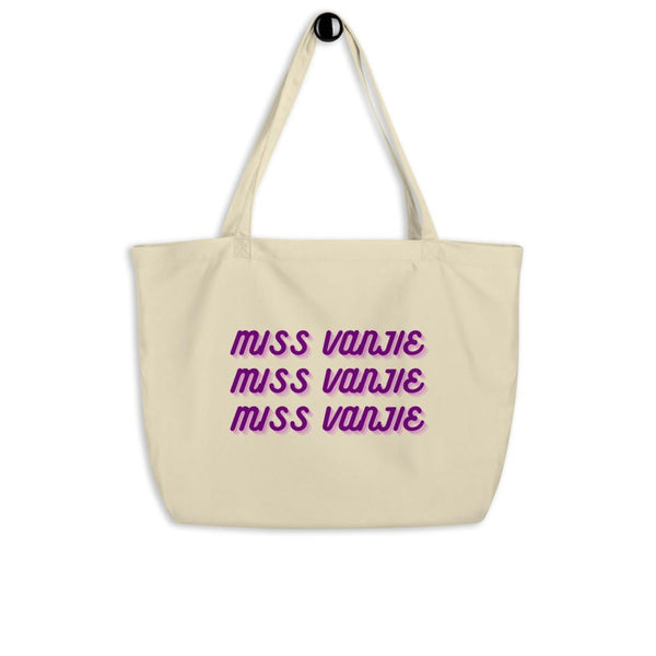 Cream canvas tote bag printed three times with purple “Miss Vanjie” lettering