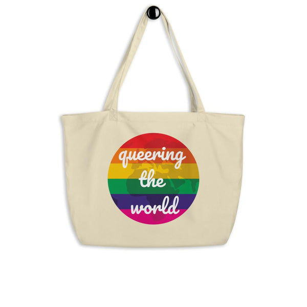 Cream organic tote bag with rainbow circle reading “queering the world”