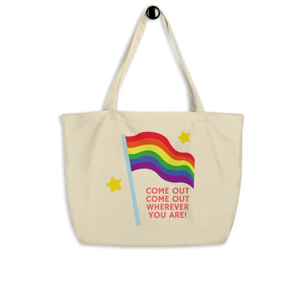 Large cream tote bag with rainbow Pride flag and “COME OUT COME OUT WHEREVER YOU ARE!” text