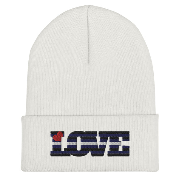 White cuffed beanie embroidered with a leather pride flag and the word “LOVE”