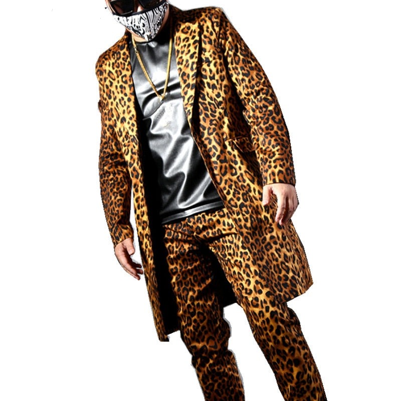 Front-facing model wearing a long leopard-print coat and matching trousers over a black top