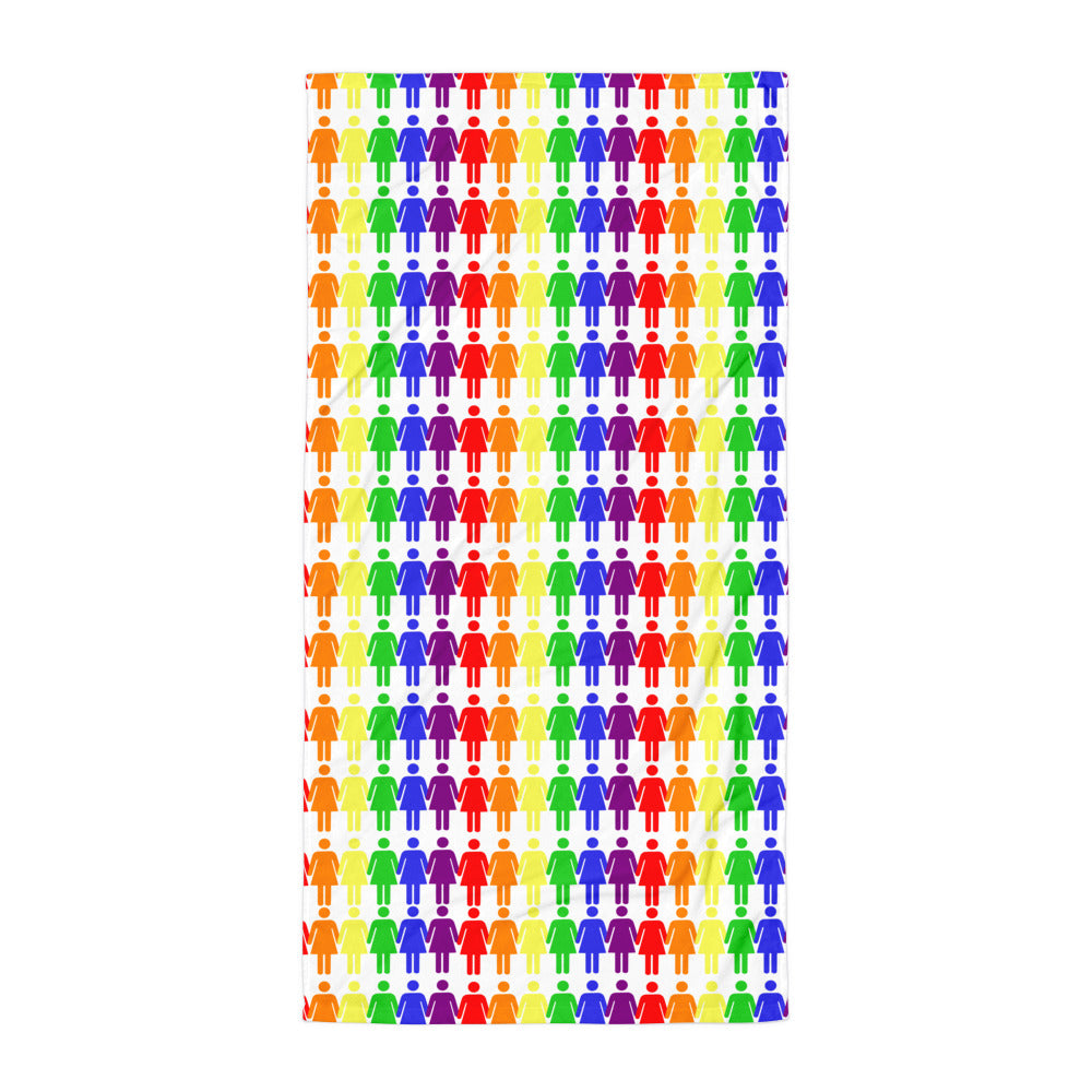 Lesbian Pride beach towel with rainbow human figure icons on sand, a tattooed man in black swim briefs lies flat, arms at sides.