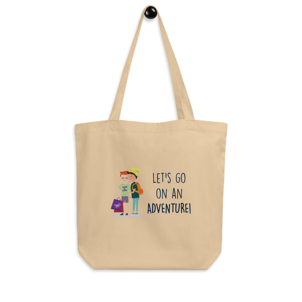 Front view of a natural canvas tote reading “LET'S GO ON AN ADVENTURE!” with two illustrated people