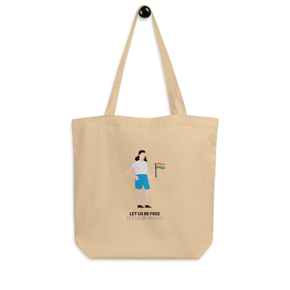 Natural canvas tote bag with a person holding a rainbow flag and “LET US BE FREE LET US BE PROUD” text