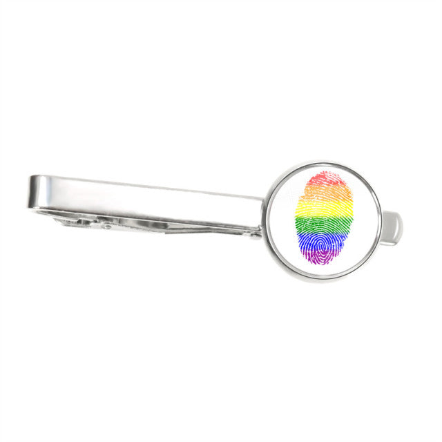 Silver tie clip with a round rainbow fingerprint design, shown from the side