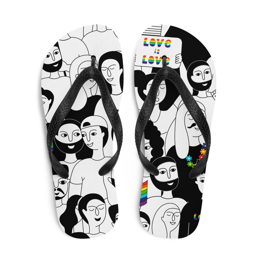 LGBT flip-flops with bold black-and-white cartoon faces, rainbow details, and vibrant puzzle pieces rest by a CLAME mag on white.