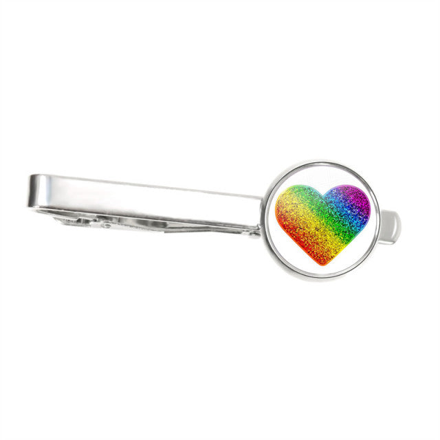 Silver tie clip with a round setting displaying a glittery rainbow heart