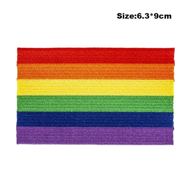 chinos gays: Black leather jacket with LGBT Pride Iron On Embroidered Patch, surrounded by rainbow ribbon, rainbow chain