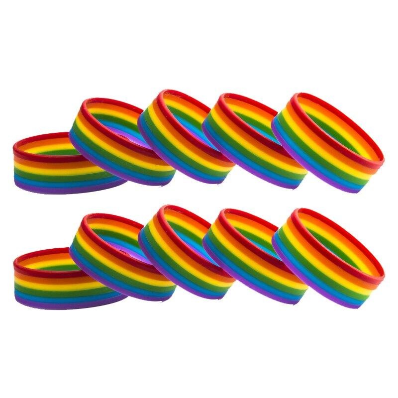 Ten rainbow-striped rubber wristbands arranged in two rows on a white background