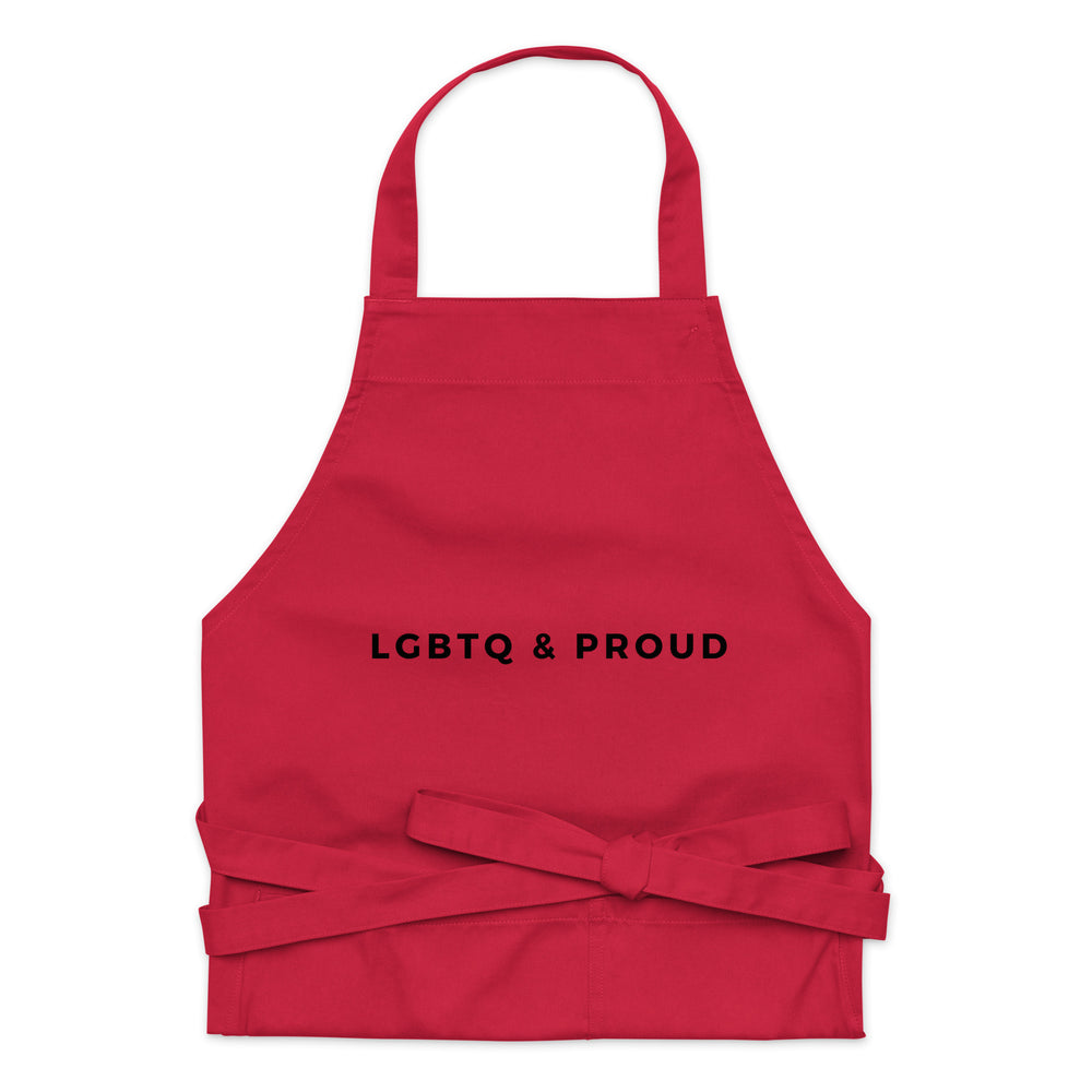 Front-view red apron with neck loop, waist ties, and “LGBTQ & PROUD” lettering
