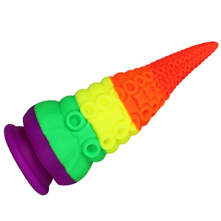 Rainbow silicone tentacle dildo shown diagonally, with a purple flared base and textured rings