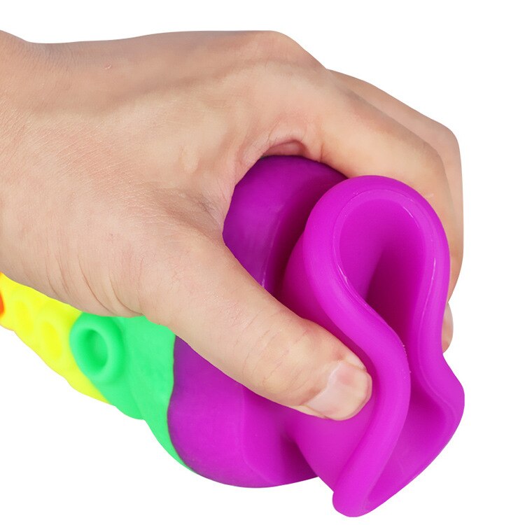 Hand holding a purple tentacle dildo with rainbow-colored ridges