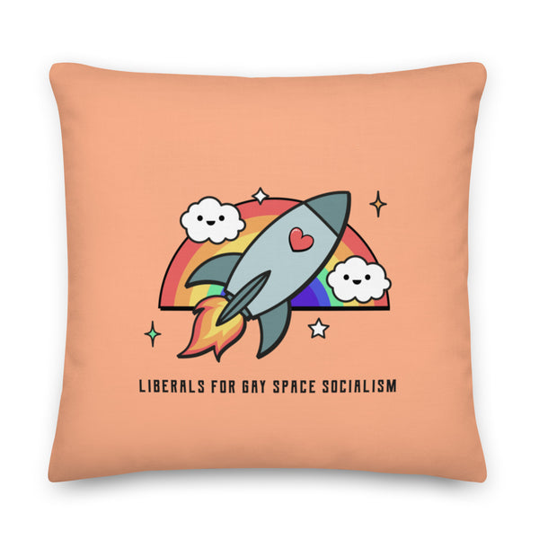 Peach square pillow with a cartoon rocket, rainbow, clouds, and the text “LIBERALS FOR GAY SPACE SOCIALISM”