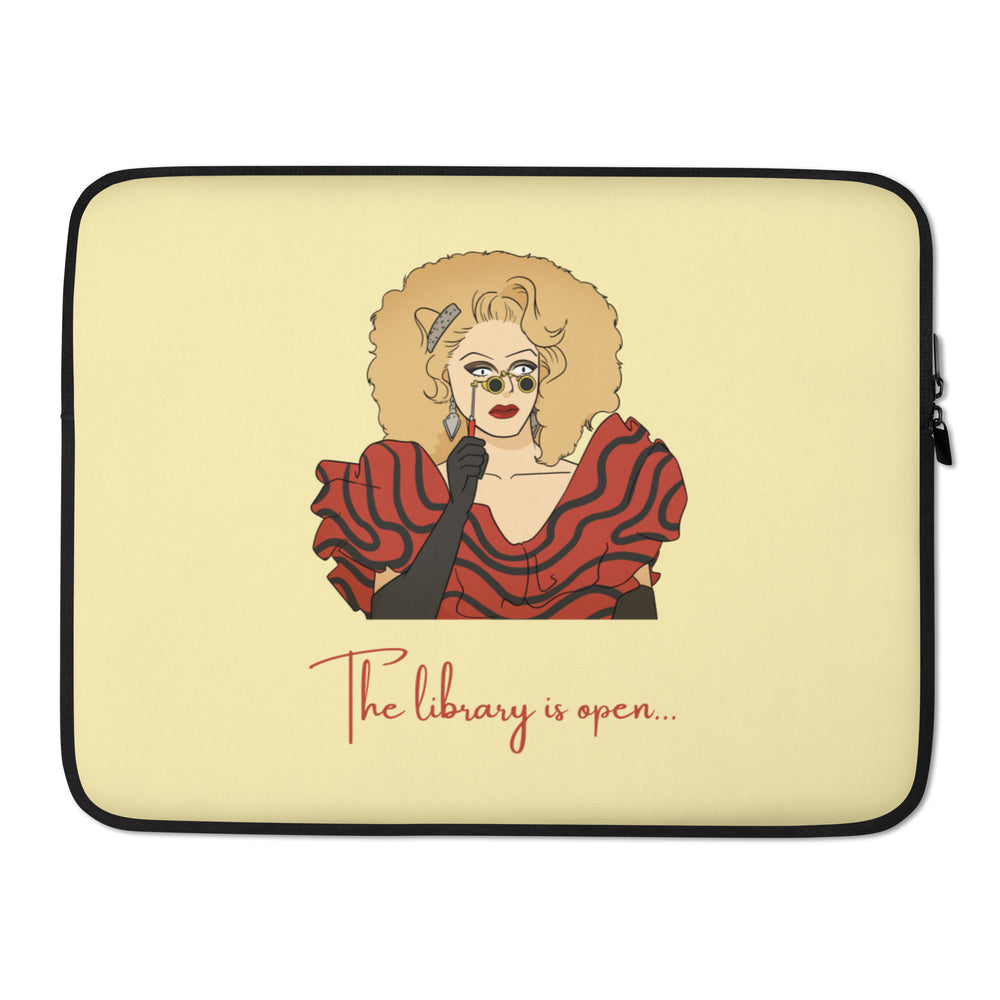 Front view of a pale yellow laptop sleeve with a drag queen illustration and “The library is open...”