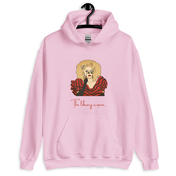 Front view of a light pink hoodie with a drag queen graphic and “The library is open…” text