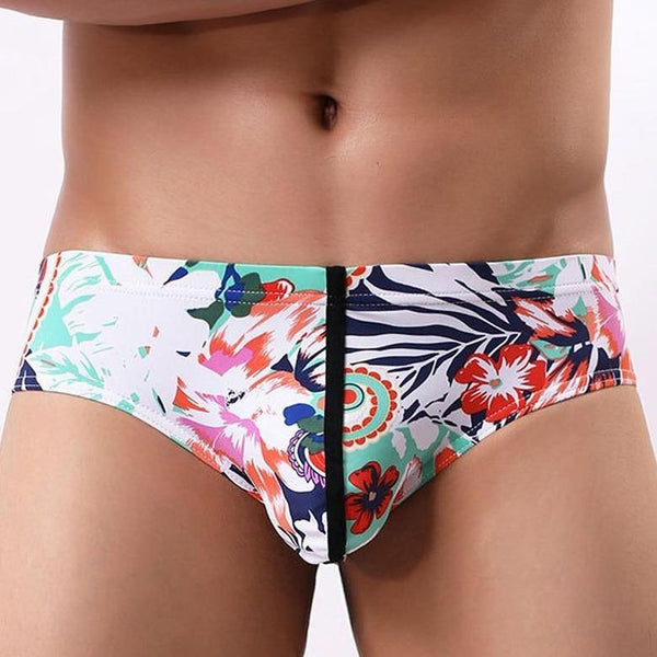 Close-up of a model wearing white floral-print briefs with a black center seam