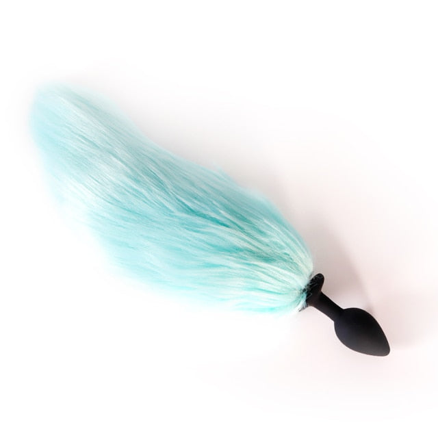 Black furry butt plug with a long light-blue tail, shown diagonally on a white background