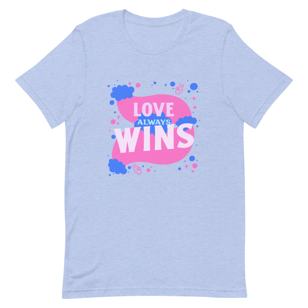 Front view of a light blue T-shirt reading “LOVE ALWAYS WINS” in pink and blue.