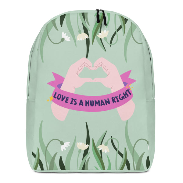 Front view of a mint-green floral backpack with a pink “LOVE IS A HUMAN RIGHT” banner
