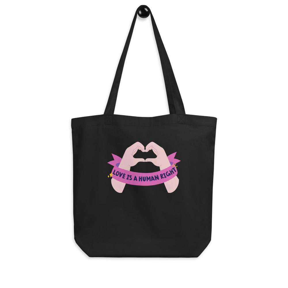 Front view of a black tote bag with two hands forming a heart and “LOVE IS A HUMAN RIGHT” text