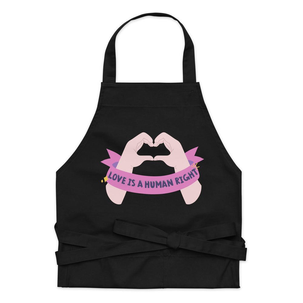 Front view of a black apron with hands forming a heart and “LOVE IS A HUMAN RIGHT” banner