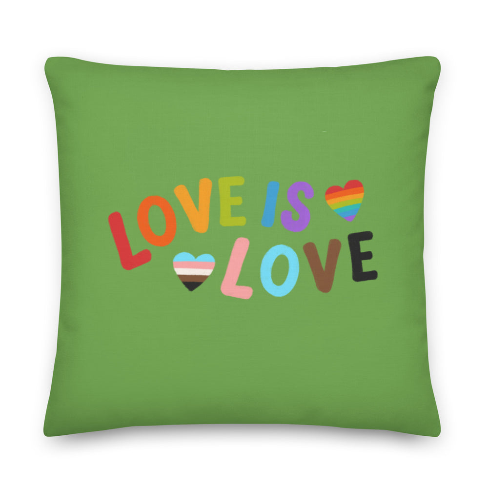 Green square pillow with colorful “LOVE IS LOVE” lettering and two striped hearts