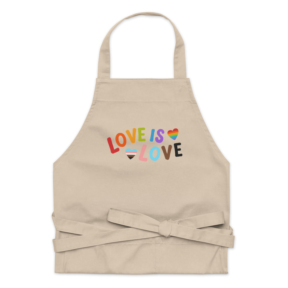 Front-facing beige apron with colorful “LOVE IS LOVE” text and rainbow hearts