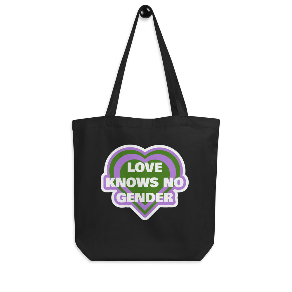 Front view of a black tote bag with a purple and green heart reading “LOVE KNOWS NO GENDER.”