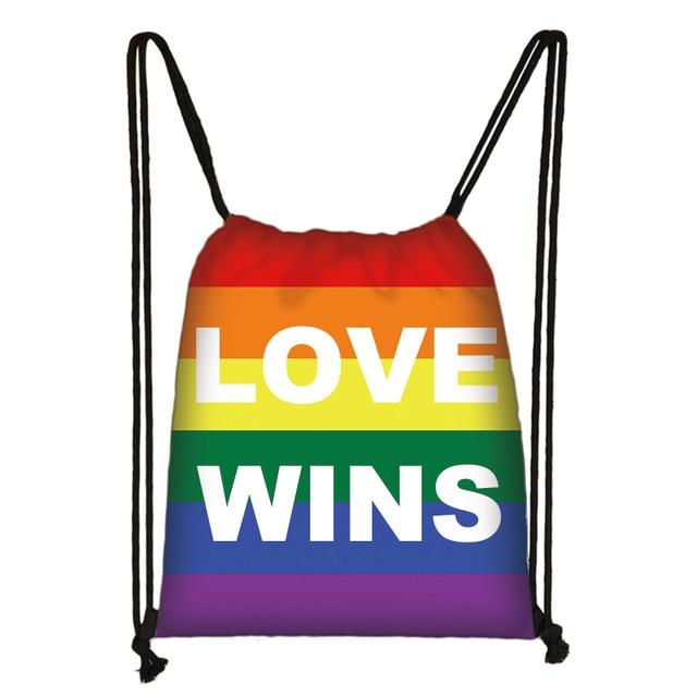Rainbow Pride drawstring bag with white “LOVE WINS” lettering