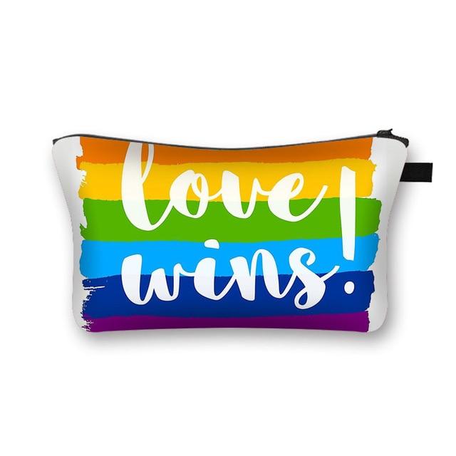 Rainbow Pride cosmetic pouch with white “Love wins.” lettering and black zipper