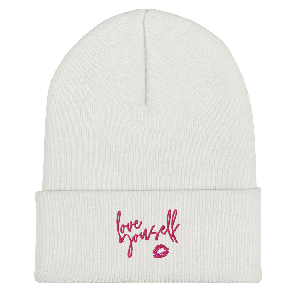 White cuffed beanie with pink “Love yourself” script and lips graphic