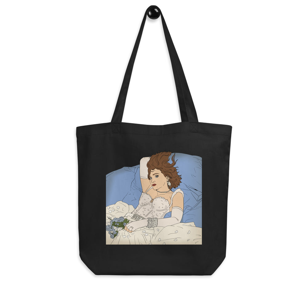 Black tote bag with long straps and a vintage-style illustration of a woman in bed