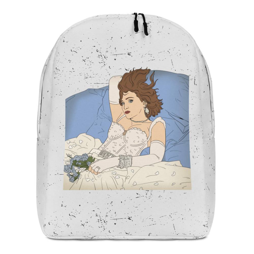 Front view of a white speckled backpack showing a reclining woman in lingerie with flowers