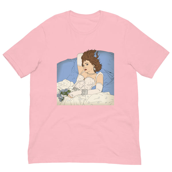 Front view of a pink T-shirt with a vintage-style illustration of a woman reclining in bed