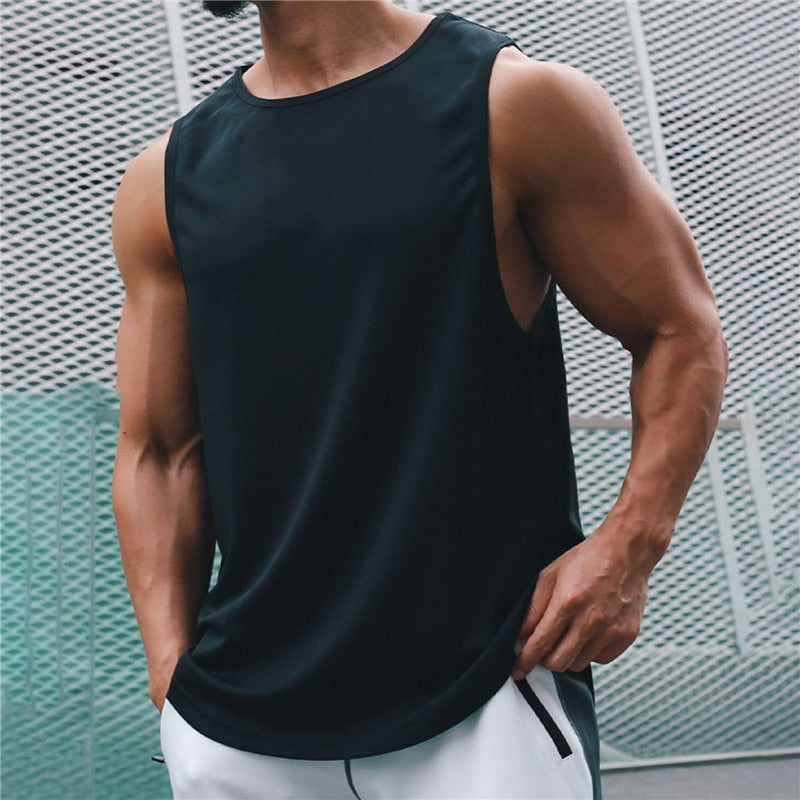 Cropped muscular person wearing a black loose-fit sleeveless athletic tank top