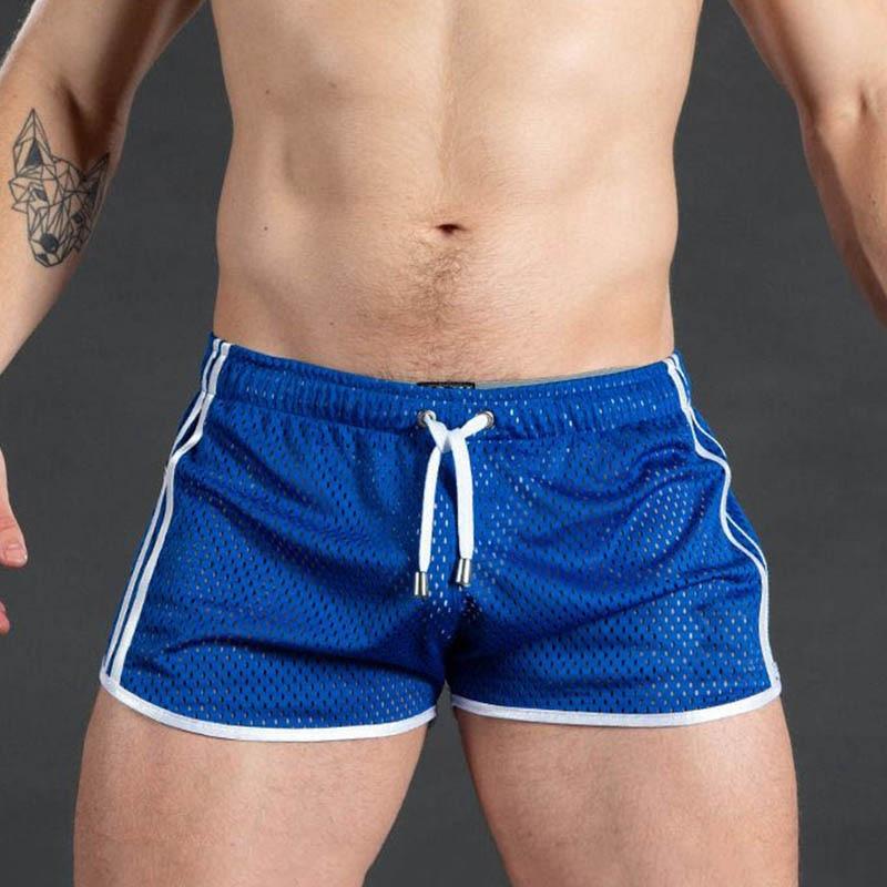 Blue mesh athletic shorts with white piping and drawstring, shown on a model