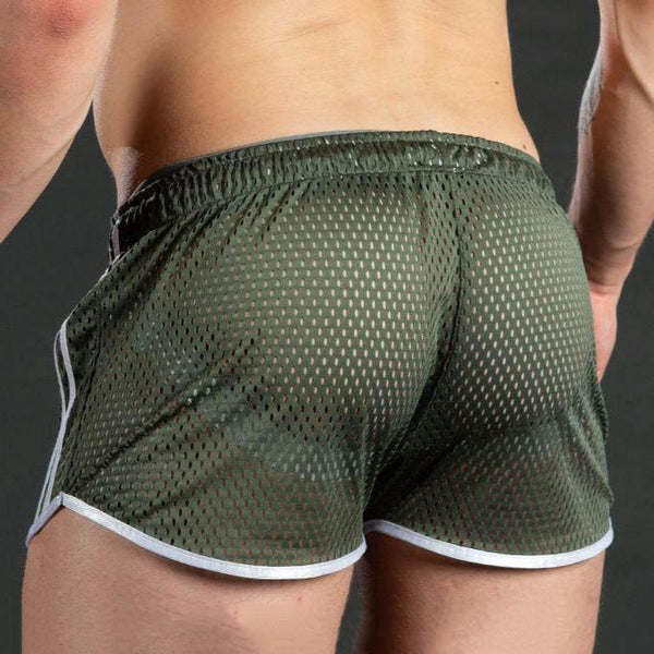 Rear view of a model wearing dark green mesh athletic shorts with white trim