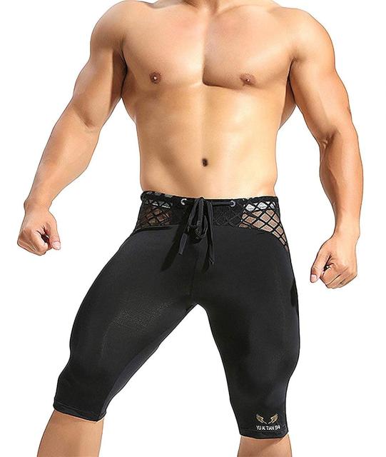 Front view of black mesh compression shorts with crisscross side panels and drawstring waist