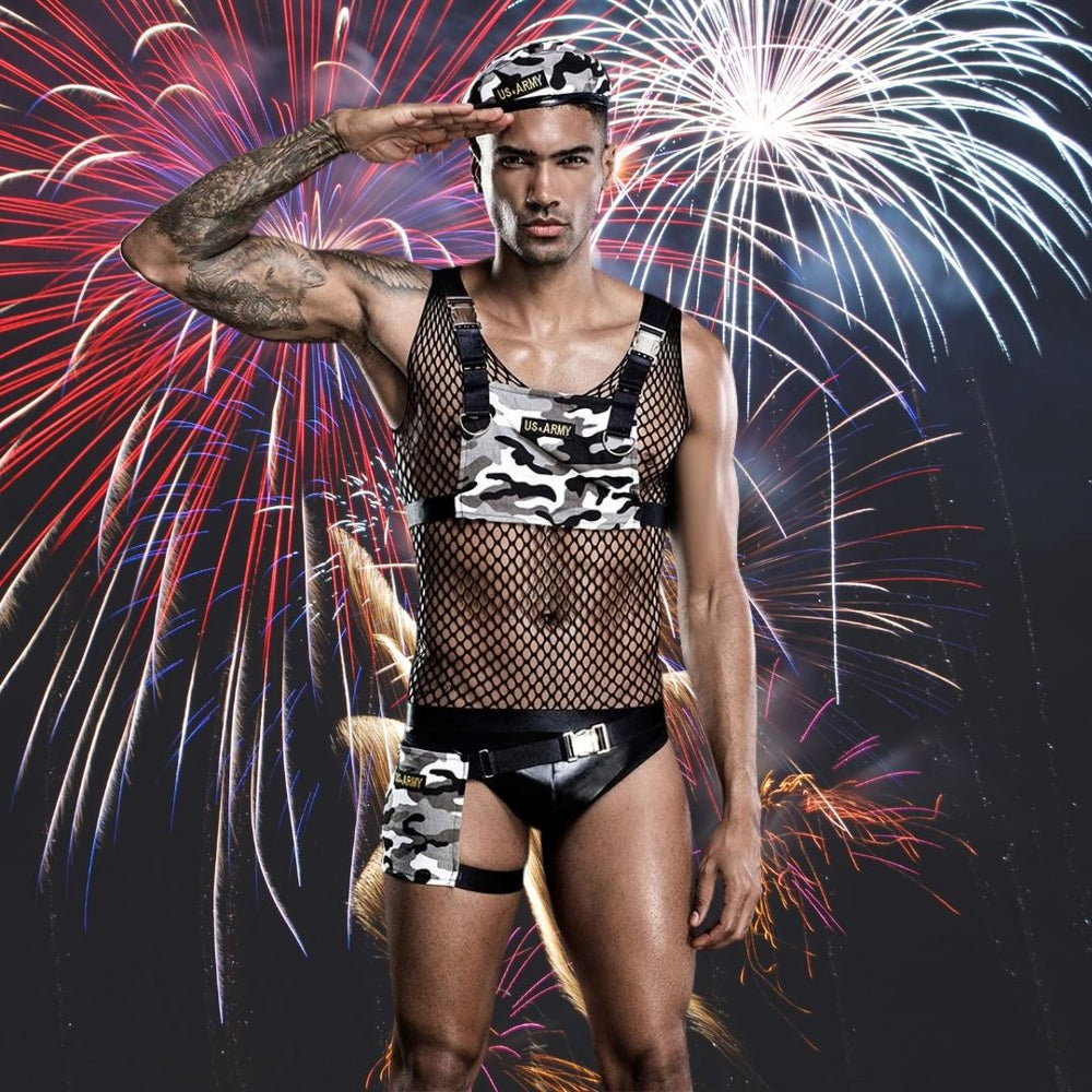 Model wearing a camouflage US Army costume with black fishnet top, straps, briefs and thigh band
