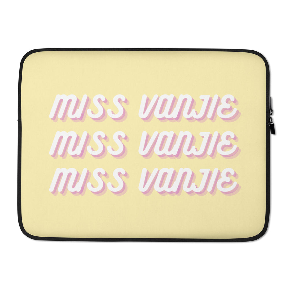 Front view of a yellow laptop sleeve reading “MISS VANJIE” in pink and white lettering
