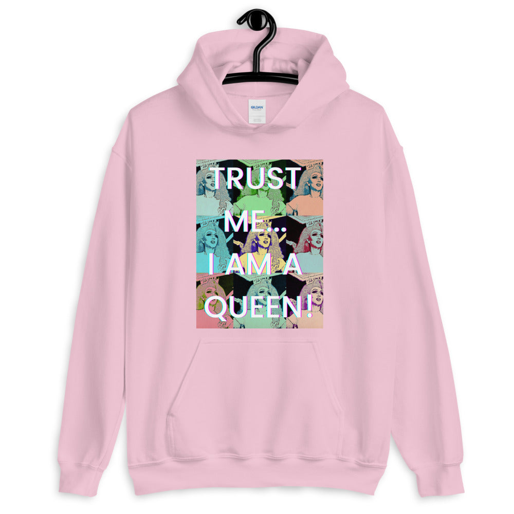 Close-up of pink hoodie with “TRUST ME... I AM A QUEEN!” pop-art graphic