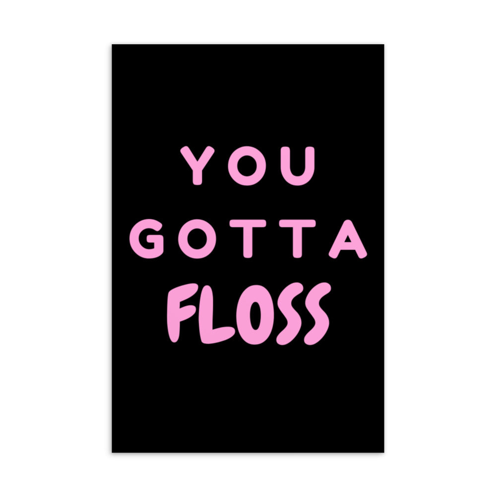 Black postcard with pink lettering reading “YOU GOTTA FLOSS”